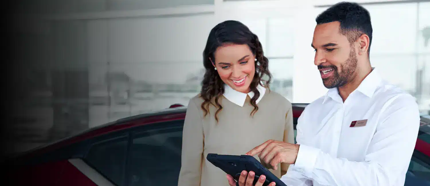 two people viewing owners manual and guides on tablet
